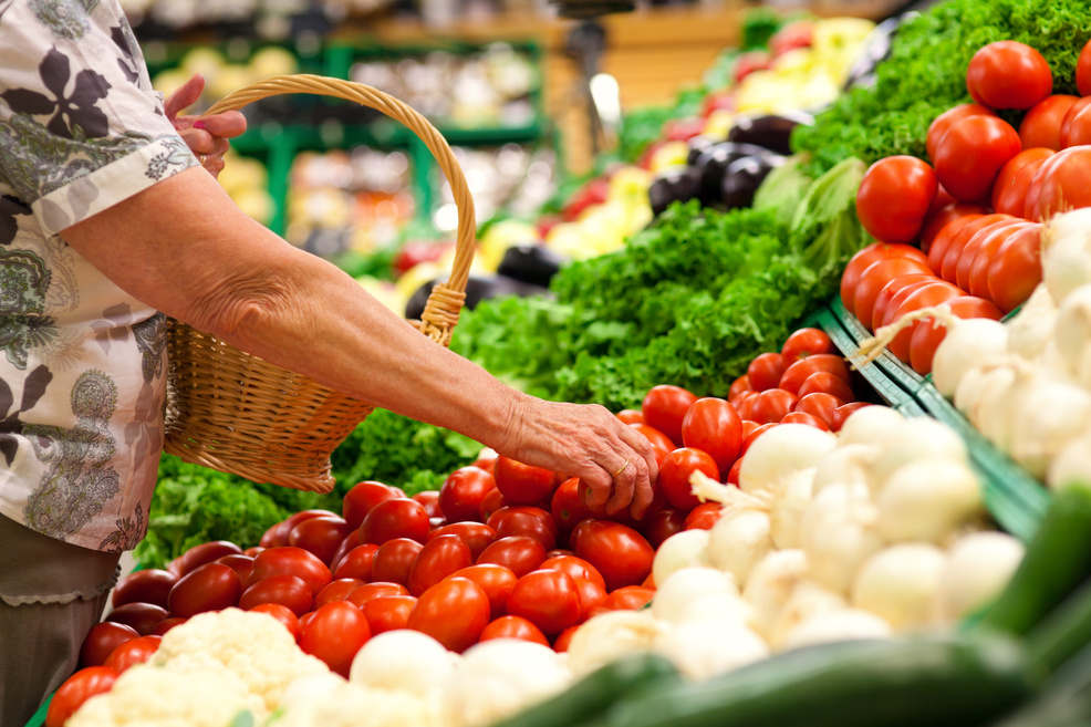 Senior woman in supermarket shopping groceries