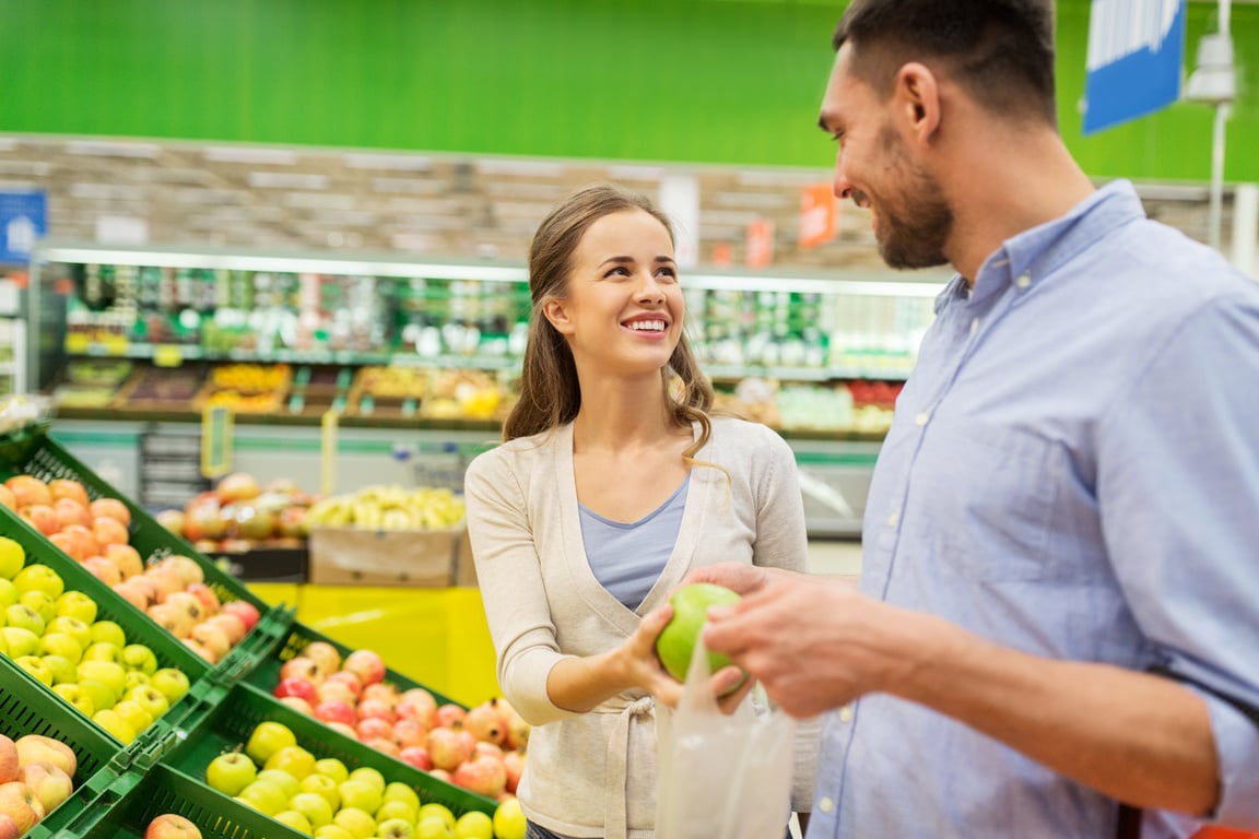 Couple Buying Apples at Grocery Store